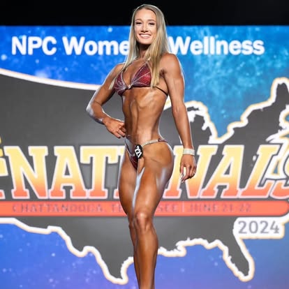 Legion athlete posing on stage at the NPC Women's Wellness Nationals 2024