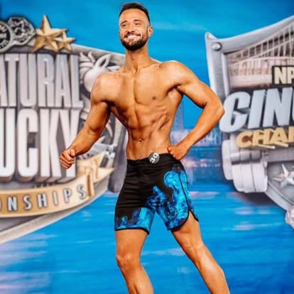 Legion men's physique athlete on stage at a Kentucky natural championship